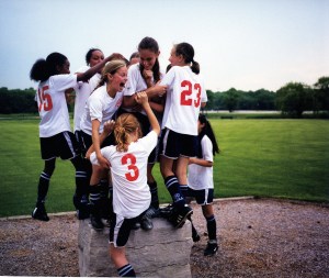 Girls sports team celebrating victory